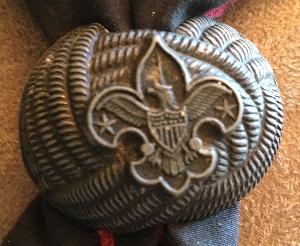 A modern Boy Scouts of America metal neckerchief slide shown against a plain background.